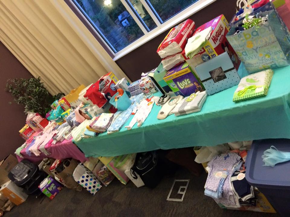 tables filled from local non-profit her community baby shower donations